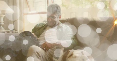 Middle Aged Man Relaxing with Dogs in Cozy Living Room