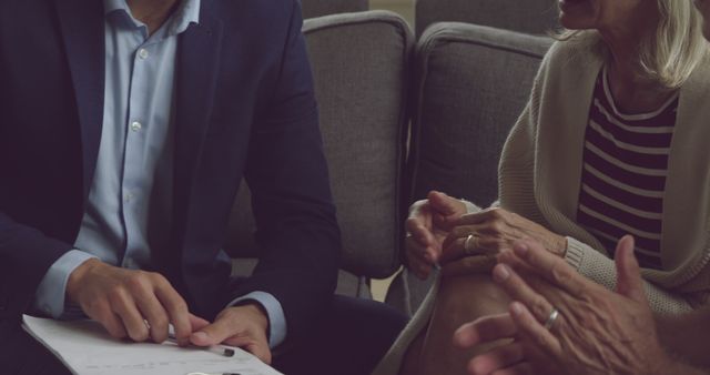 Business Meeting Between Mature Woman and Male Colleague Discussing Documents - Download Free Stock Images Pikwizard.com