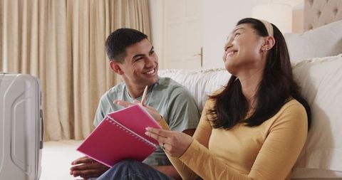 Couple Collaborating Indoors with Notes in Cozy Living Room