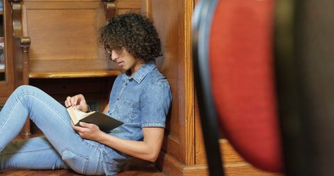 Young Man Enjoying a Book in Very Welcoming Library Corner - Download Free Stock Images Pikwizard.com