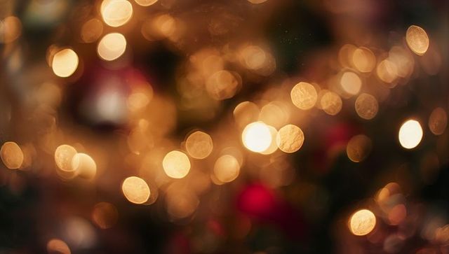 Glowing Holiday Bokeh Lights with Red Ornaments and Evergreen Blur