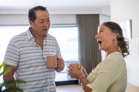 Diverse Senior Couple Enjoying Relaxed Conversation at Home