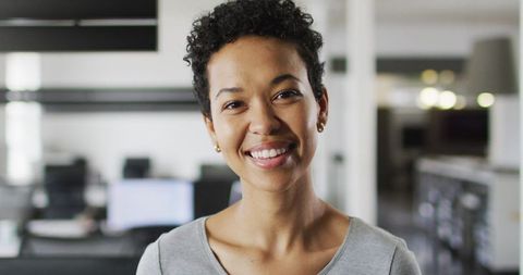 Smiling Biracial Businesswoman in Modern Office Portrait