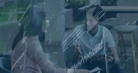 Collaborators analyzing tablet with augmented data overlay in modern coworking lounge