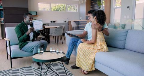 Financial advisor meeting couple in contemporary living room