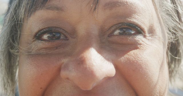 Close-up of smiling senior woman's eyes with sunlight reflection - Download Free Stock Images Pikwizard.com