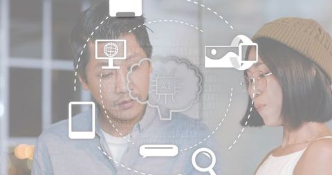 Asian colleagues collaborating with ai interface overlays in softly lit modern office