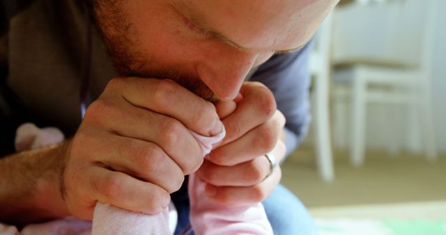 Father Kissing Baby's Foot with Love and Tenderness - Download Free Stock Images Pikwizard.com