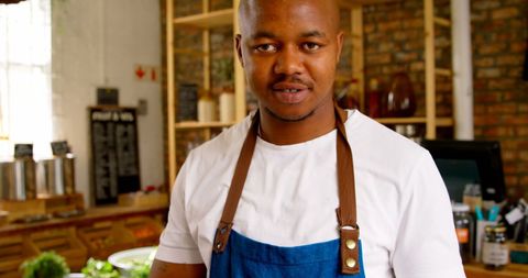 Confident Male Staff Using Digital Tablet in Urban Grocery Store