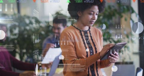 Woman Analyzing Data on Tablet in Modern Office Environment