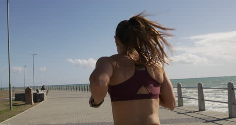 Fitness Enthusiast Running on Seafront Promenade
