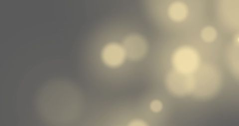 Abstract golden bokeh lights on grey background