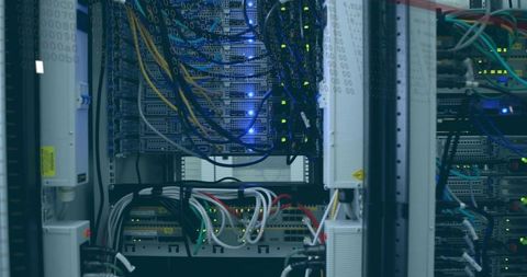 Rack-mounted servers and network switches glowing with leds and cabling in datacenter