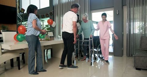 Nurse Assisting Senior Woman with Walker in Rehabilitation Center