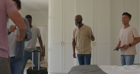 Friends arriving with luggage in cozy home for wedding celebration
