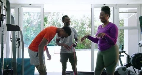 Couple Receiving Personal Training in Home Gym