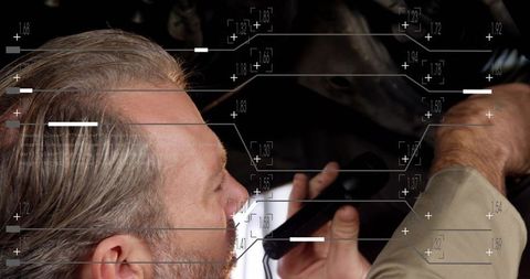 Mechanic inspecting car engine with diagnostic scanner and digital HUD overlay
