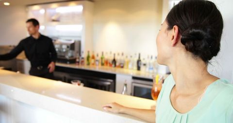 Woman Enjoying Evening Out at Trendy Bar Counter