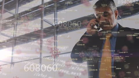 Businessman Analyzing COVID-19 Data in Modern Office Environment