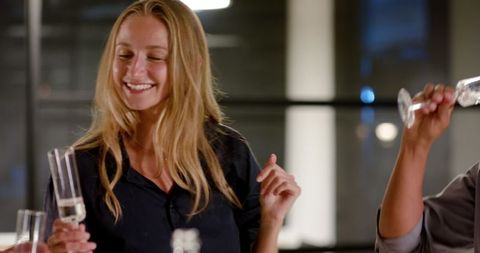 Young professionals celebrating with champagne during evening event