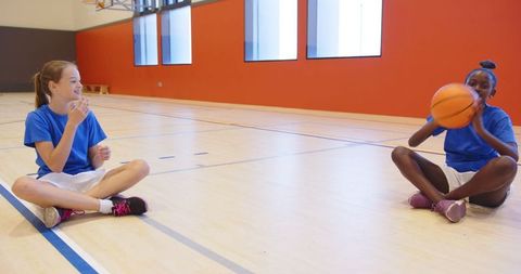 Diverse Girls Enjoying Basketball in Indoor Court