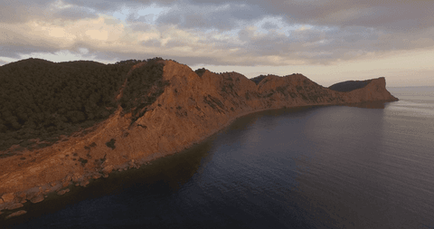 transparent coastal cliffs at sunset with cloudy sky - Download Free Stock Videos Pikwizard.com