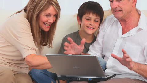 Happy Multigenerational Family Bonding Over Laptop