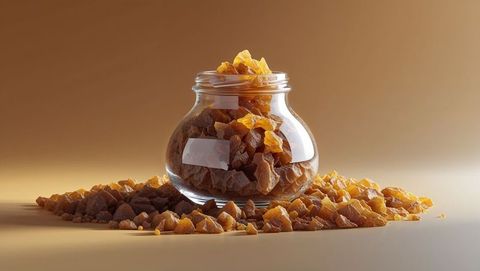 Glass jar filled with dried frankincense chunks on table