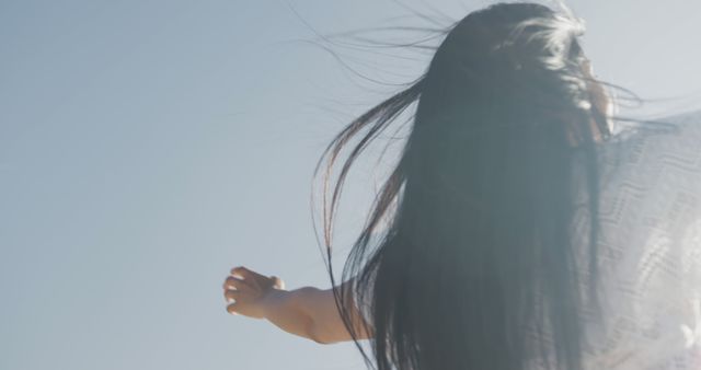 Woman with Outstretched Arms Enjoying Freedom Under Clear Sky - Download Free Stock Images Pikwizard.com