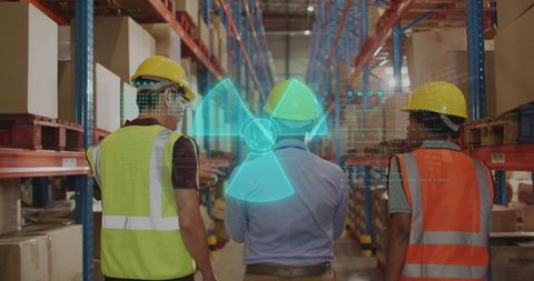 Warehouse staff observing holographic radiation symbol with technology interaction