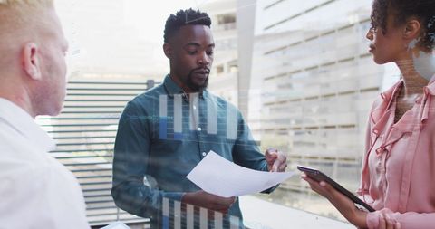 Diverse team analyzing financial report in modern office
