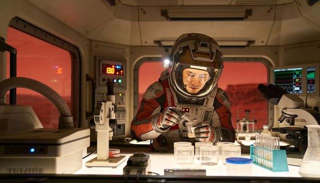 Mars scientist in space suit conducting sample analysis inside habitat laboratory module
