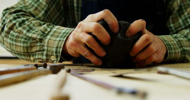 Focused Potter Shaping Clay with Tools on Workbench - Download Free Stock Images Pikwizard.com