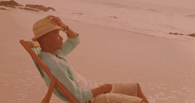 Man Relaxing on Beach in Summer Attire with Straw Hat - Download Free Stock Images Pikwizard.com