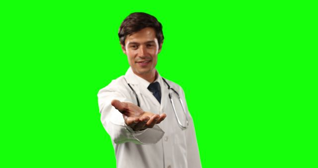 Picture depicts a doctor in a white coat with a stethoscope around the neck, extending a hand in a gesture of help. Green screen background allows for easy replacement with various settings. Useful for medical advertisements, healthcare campaigns, and informative videos about medical services.