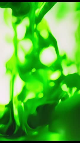 Injecting Neon Green Dye Creating Swirling Ribbons in Vertical Lab Vessel