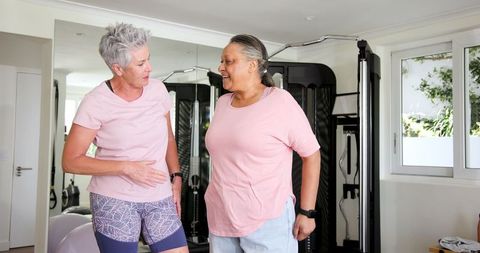 Senior Lesbian Couple Enjoying Workout Session at Home Gym