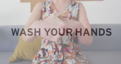 Woman disinfecting hands with safety reminder text