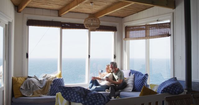 Couple Relaxing in Beachfront Home with Ocean View - Download Free Stock Images Pikwizard.com