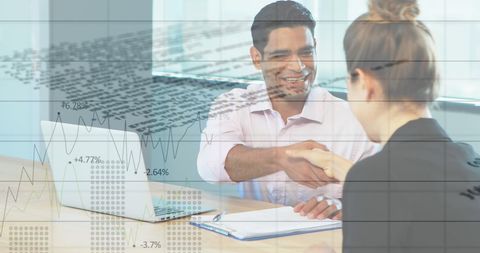 Business Partners Shaking Hands with Financial Data In Background