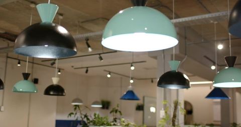 Mint-Green Dome Pendants Glowing over Industrial Coworking Space with Concrete Ceiling