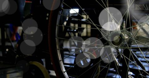 Close-Up of Wheelchair Wheel with Spokes in Dim Lighting - Download Free Stock Images Pikwizard.com