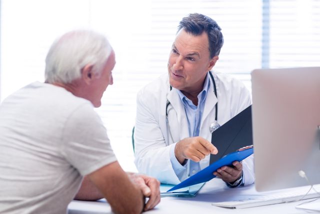 Doctor is consulting a senior male patient, discussing patient health and possible treatments. Suitable for content related to healthcare, elderly care, medical consultations, doctor-patient relationships, and health services.