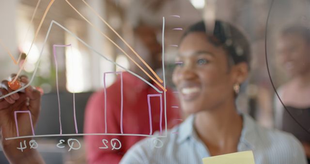 Young Businesswoman Drawing Chart on Transparent Board in Office - Download Free Stock Images Pikwizard.com