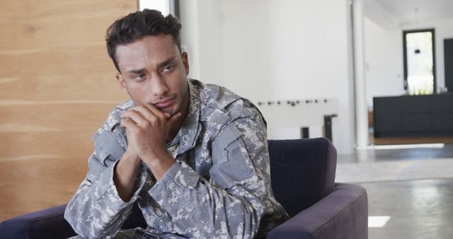 Contemplative Soldier in Uniform Sitting Indoors - Download Free Stock Images Pikwizard.com