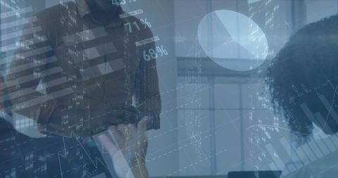 Diverse Professionals Discussing Financial Success Amid Digital Data Visualizations