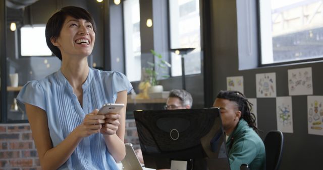 Businesswoman Enjoying Mobile Break in Modern Office - Download Free Stock Images Pikwizard.com