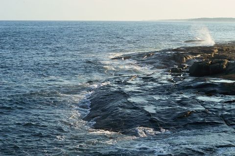 Waves Crashing on Rocky Shoreline at Dawn