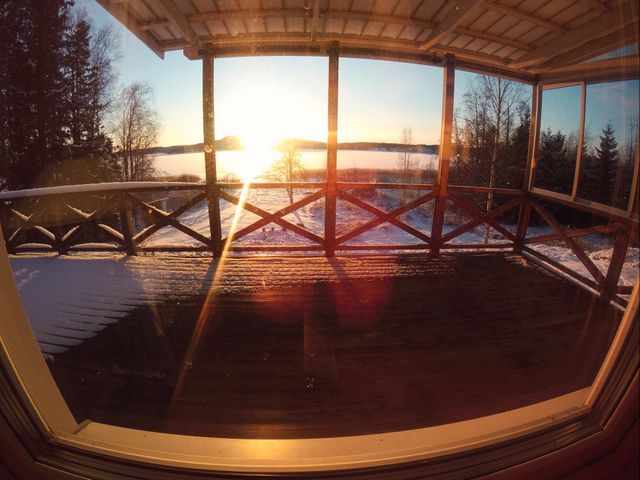 Scenic Winter Sunrise Over Frozen Lake from Cabin Porch - Download Free Stock Images Pikwizard.com