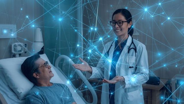 Asian Physician Using Technology to Monitor Patient Health in Hospital